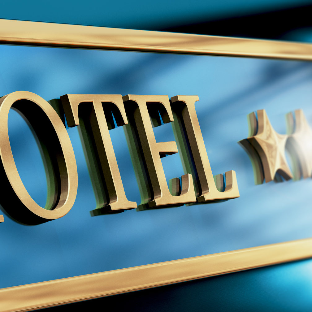 Five stars hotel sign written with golden letters over blue background. Horizontal image suitagle for header